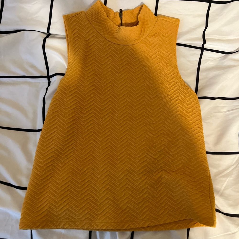 Yellow sleeveless turtleneck
